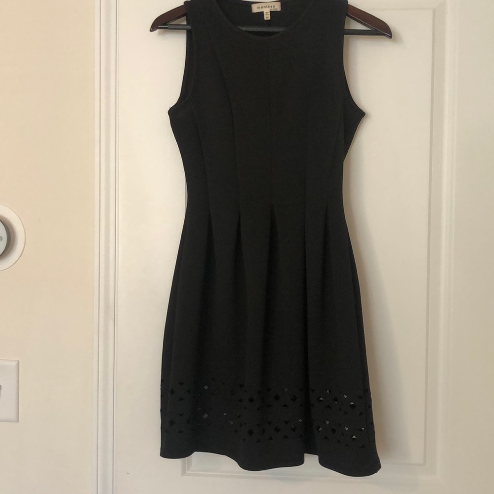 Black dress with cutout details on hemline